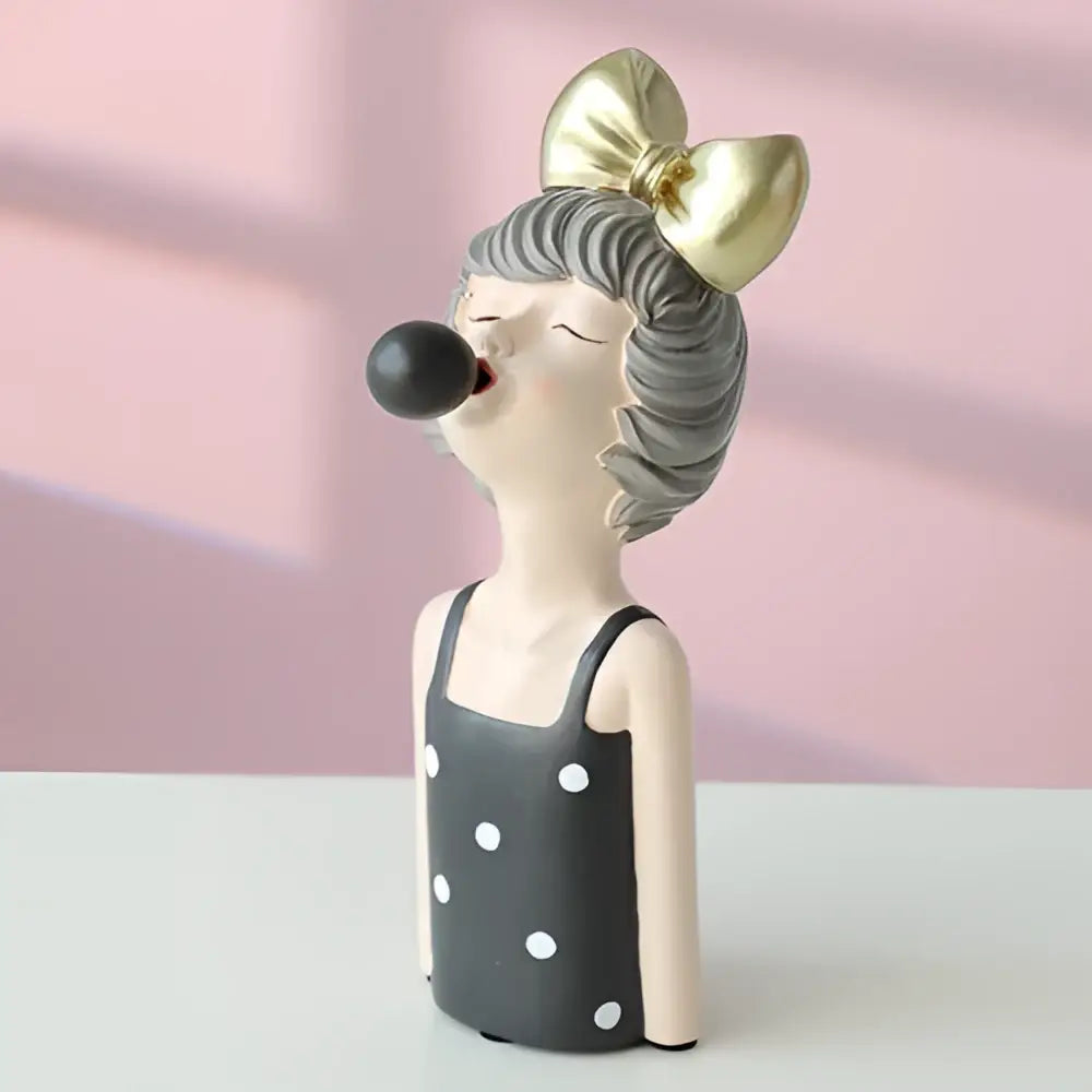 Whimsical bubble girl resin figurine in black and white polka dot dress with gold bow and gray wavy hair for decor