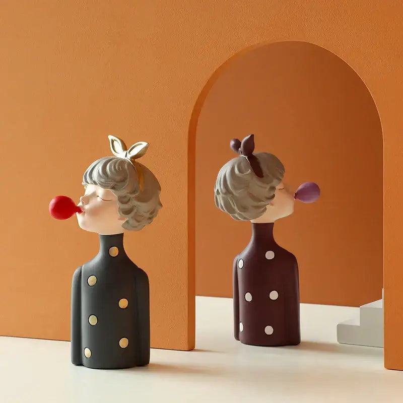 Two whimsical ceramic bubble girl resin figurines with gray hair and polka dot dresses for living room decor