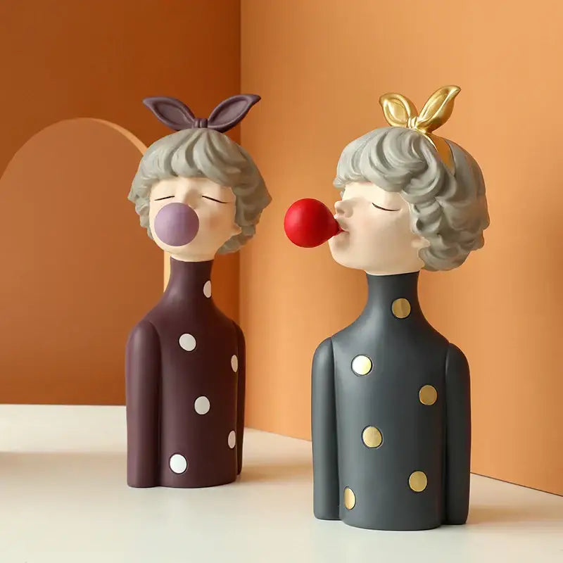 Two whimsical bubble girl resin figurines in polka dot dresses with balloons perfect for living room decor