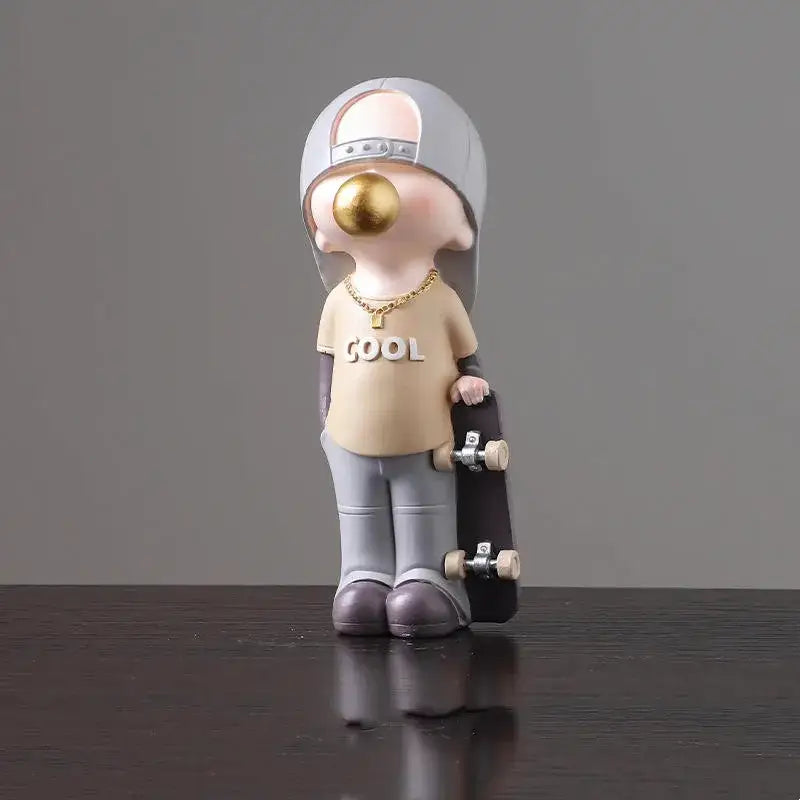 Beige resin boys sports statue by decorbites featuring stylized skateboarder with gray cap and black skateboard for bedroom decor