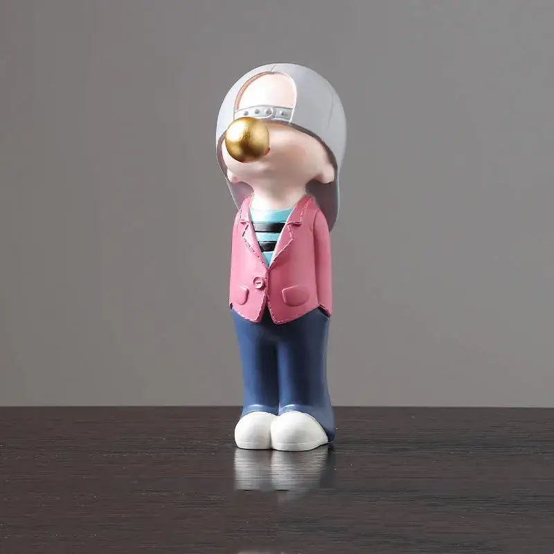 A whimsical resin boys sports statue wearing gray cap pink blazer and blue pants for decorbites boys sports decor