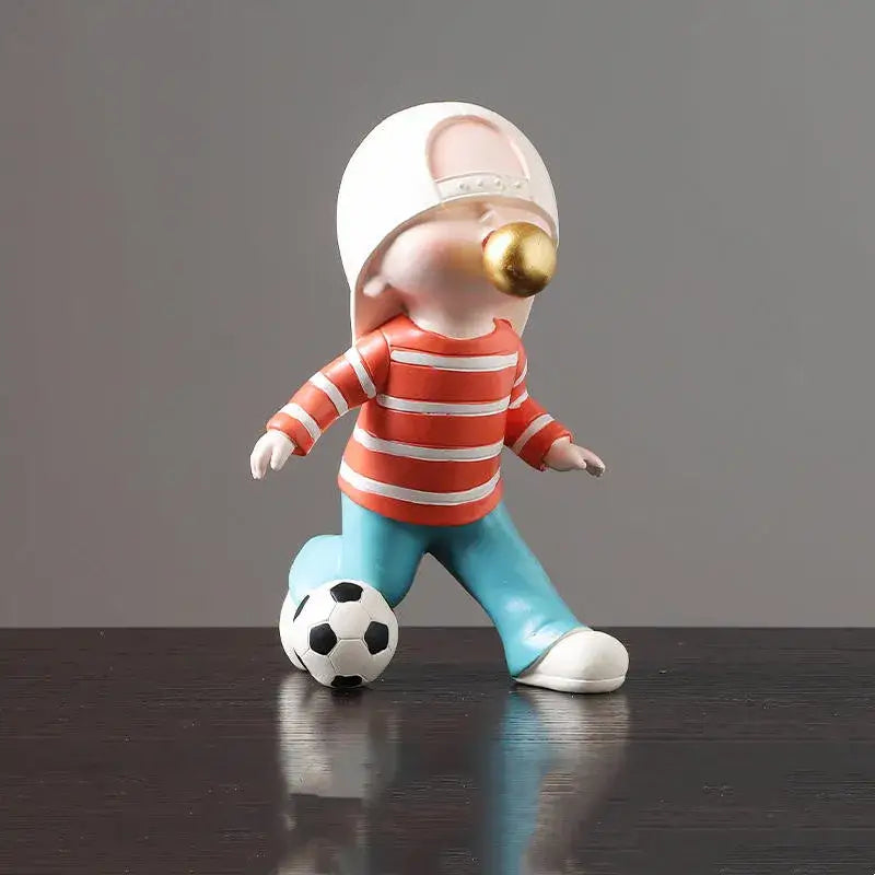 Whimsical resin boys sports statue by decorbites featuring a child in striped shirt blowing golden bubblegum ball for decorbites boys