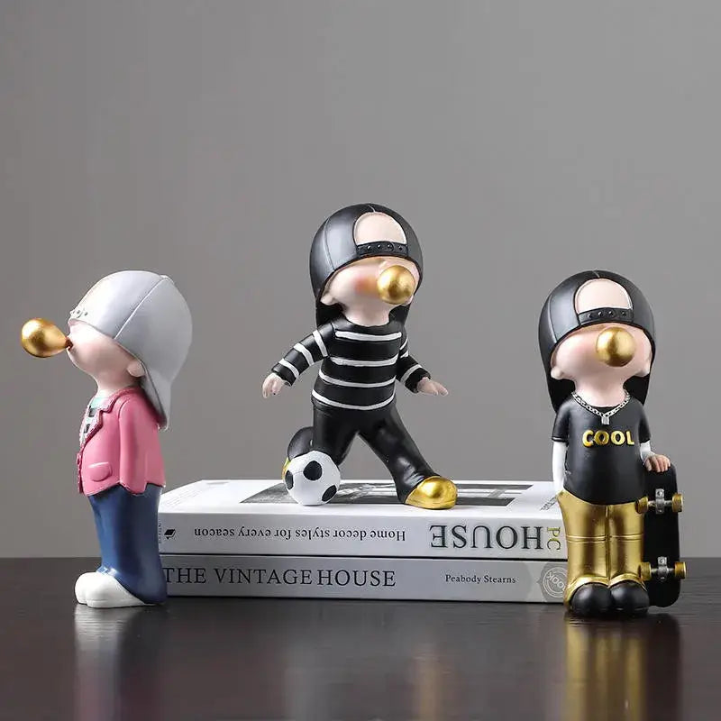 Three stylized resin boys sports statues with golden bubblegum bubbles and accessories for decorbites boys sports decor