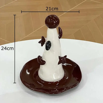 Glossy white and dark brown ceramic jewelry display stand with whimsical cone shape and star accents for bedroom decor