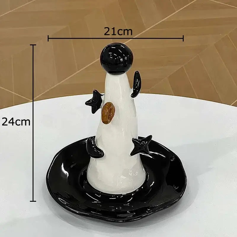 Glossy white and black ceramic jewelry display stand with star-shaped arms and golden detail for bedroom decor