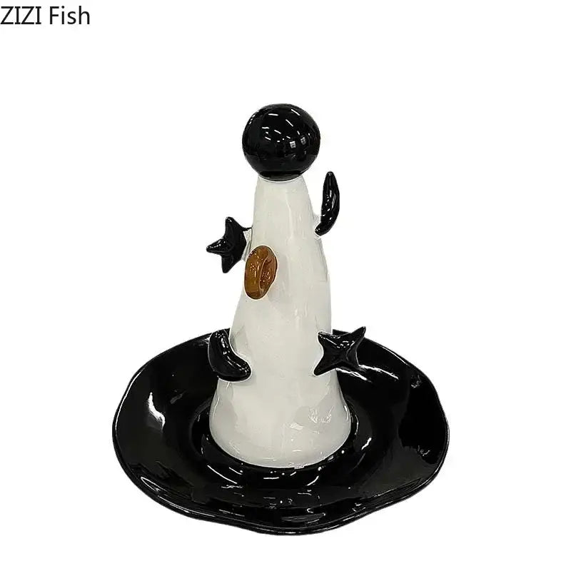 Whimsical black and white ceramic penguin jewelry display stand with glossy finish and gold chest detail for bedroom decor