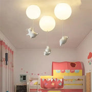 Whimsical white balloon ceiling light featuring three flying pig resin led figurines for bedroom decor