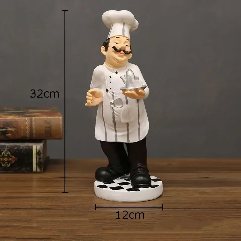 Whimsical white bearded chef resin figure in tall hat and striped apron holding silver teapot for kitchen decor