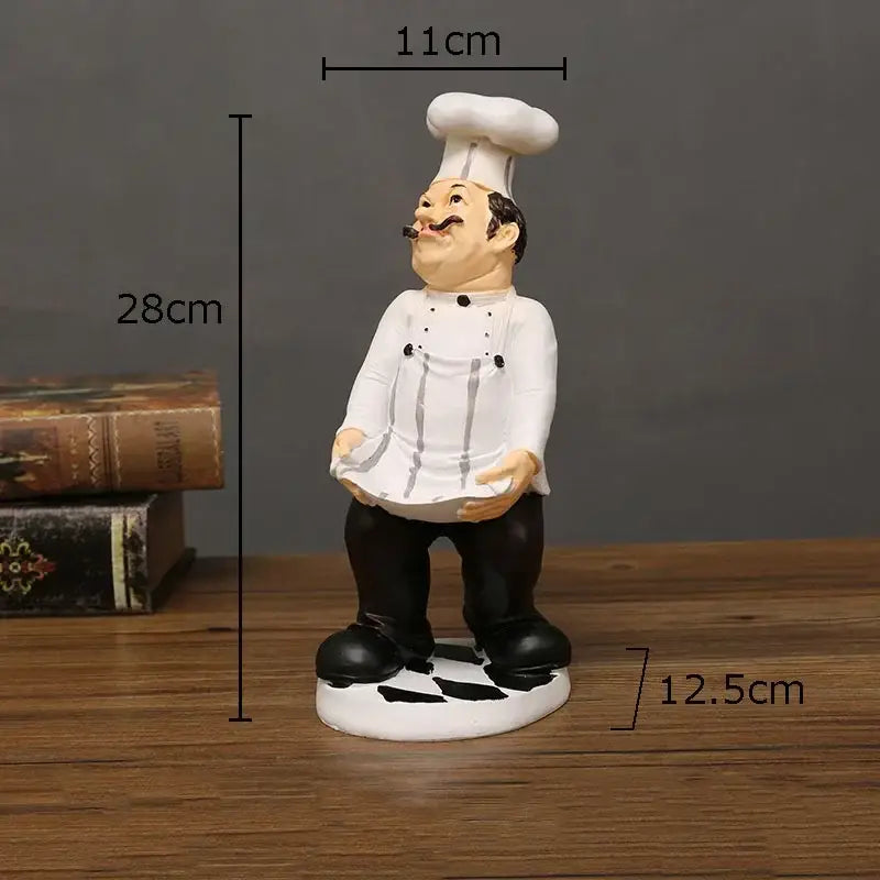 Whimsical white and black bearded chef resin figure with tall toque standing on circular base kitchen decor