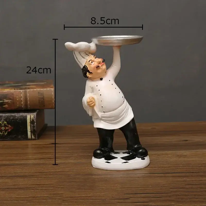 Whimsical white bearded chef resin figure in black hat holding silver tray for kitchen decor