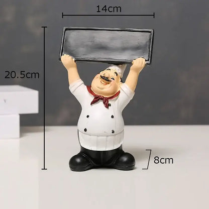 A cheerful chubby bearded chef resin figure in white coat holding a chalkboard for kitchen decor