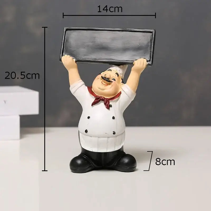 A cheerful chubby bearded chef resin figure in white coat holding a chalkboard for kitchen decor