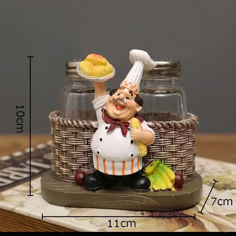 Whimsical bearded chef resin figure in white coat with red bow tie holding yellow pastries inside woven basket kitchen decor