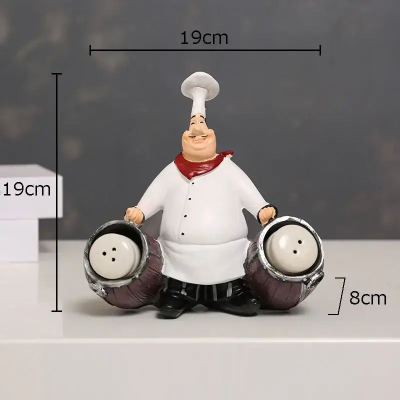 Whimsical white bearded chef resin figure with red scarf holding salt and pepper shakers for kitchen decor
