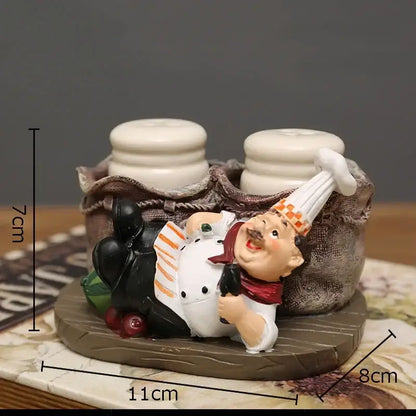 Whimsical white bearded chef resin figure in white coat reclining on wooden base with ceramic salt and pepper shakers