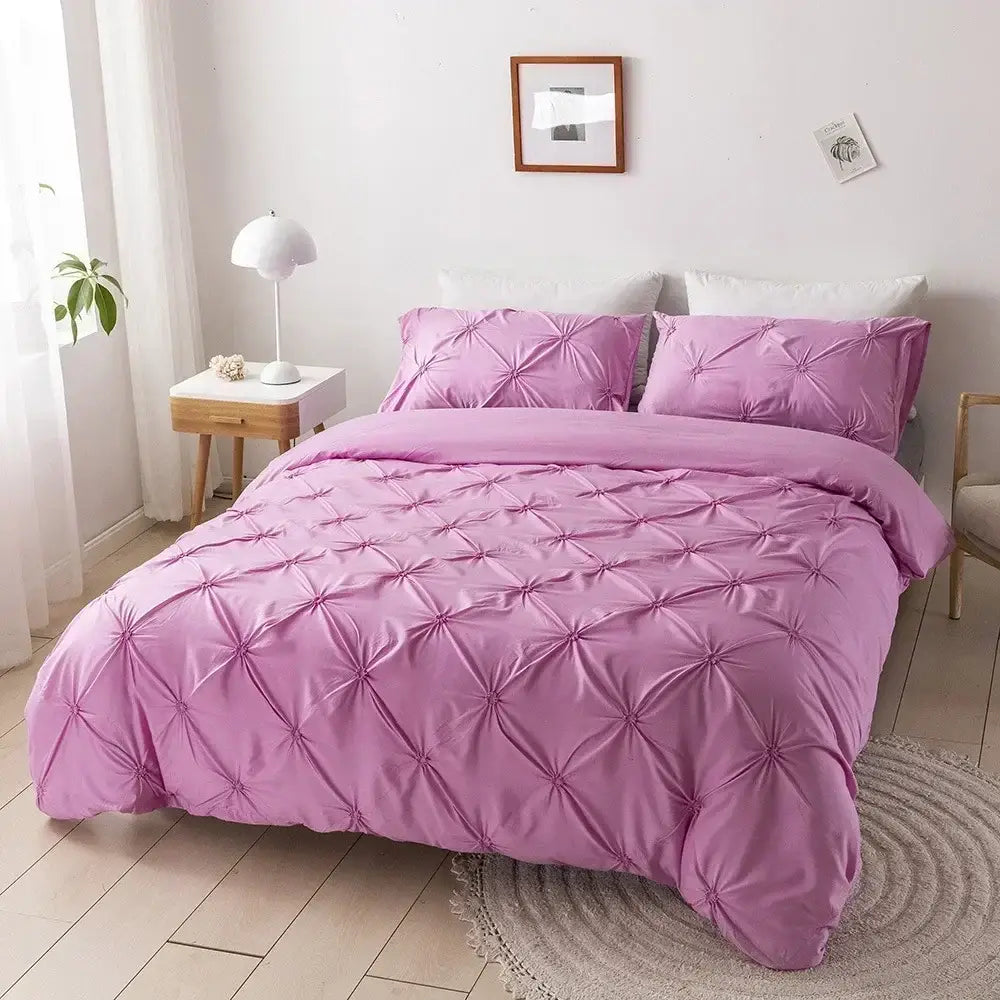 Pink quilted duvet cover set with satin-like finish and diamond-shaped tufting for elegant bedroom bedding
