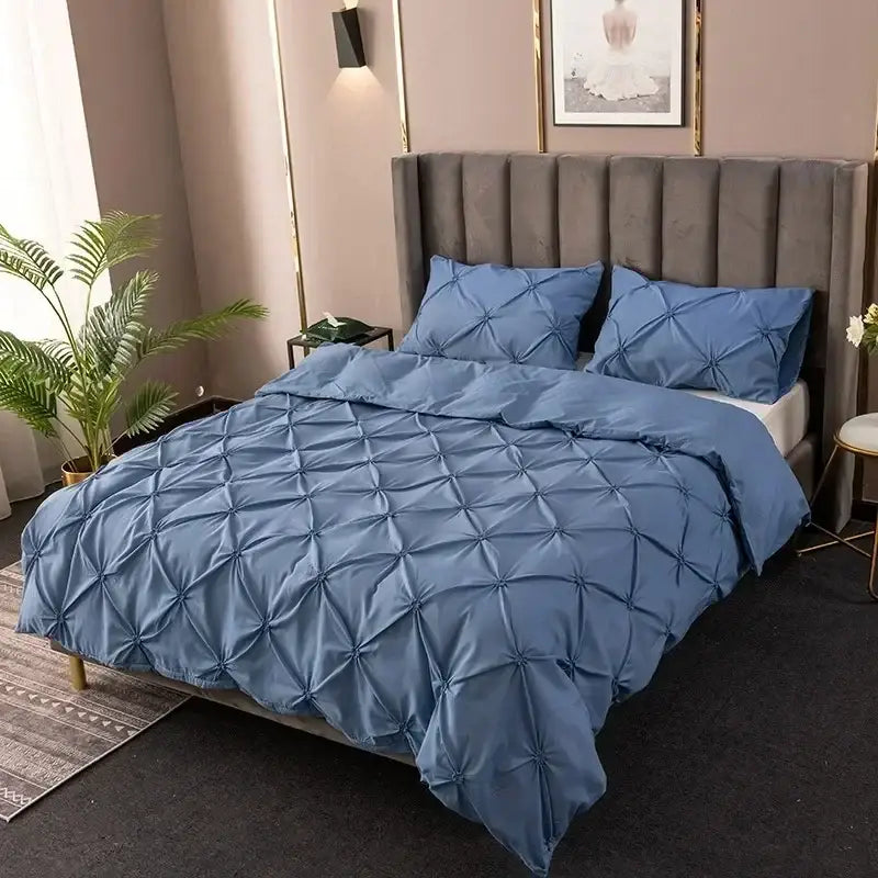 Blue quilted duvet cover set with diamond pattern complementing white 3d pinch pleat cover set bedding