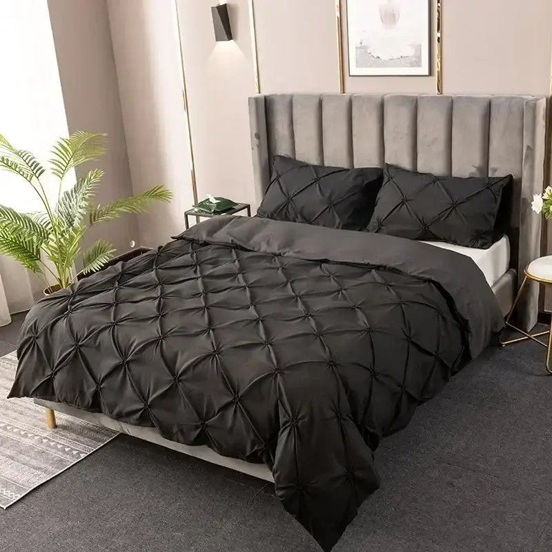 Black quilted duvet cover set featuring a sleek modern design for bedroom use in a white 3d pinch pleat style