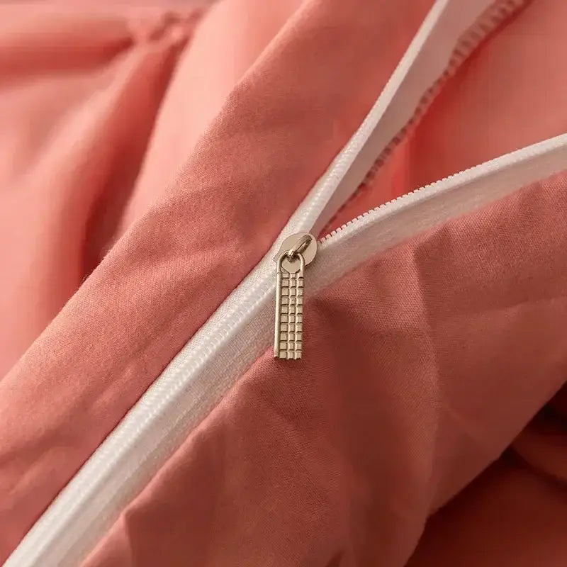 Metallic zipper pull with grid pattern on white zipper track of coral fabric in white 3d pinch pleat duvet cover set