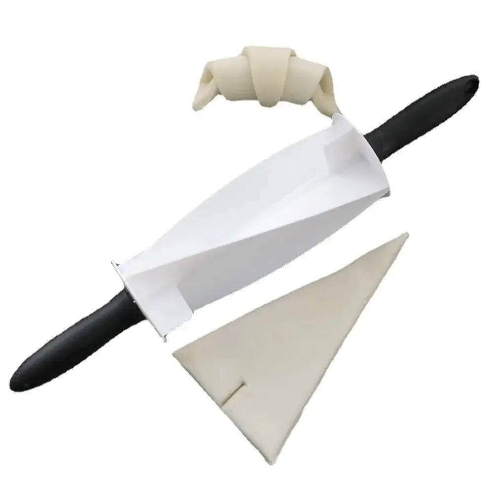 White plastic and black handled decorbites croissant bread wheel cutter with triangular base and rolled pale dough