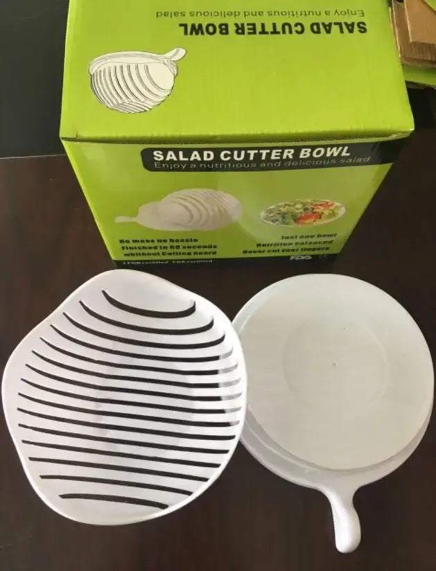 White and black easy salad cutter bowl with handle and parallel ridges designed for slicing vegetables easily