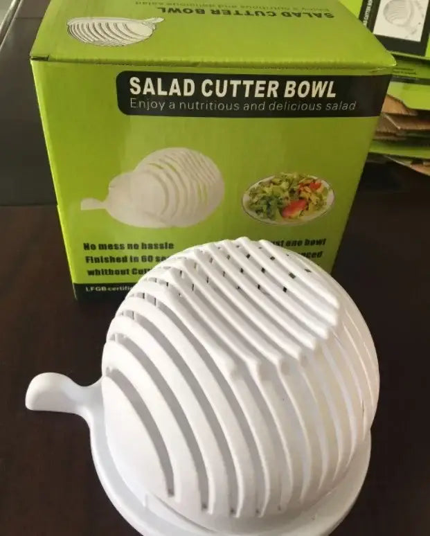 White plastic and black easy salad cutter bowl with handle and concentric ridges for slicing vegetables efficiently