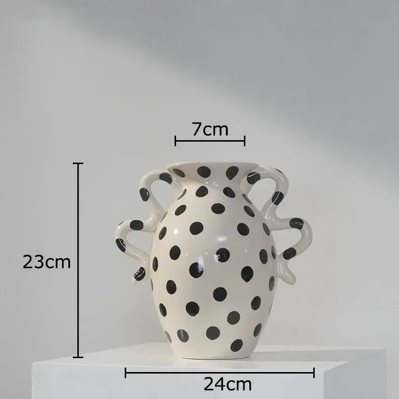 White ceramic vase with black polka dot pattern and sculpted handles for living room decor