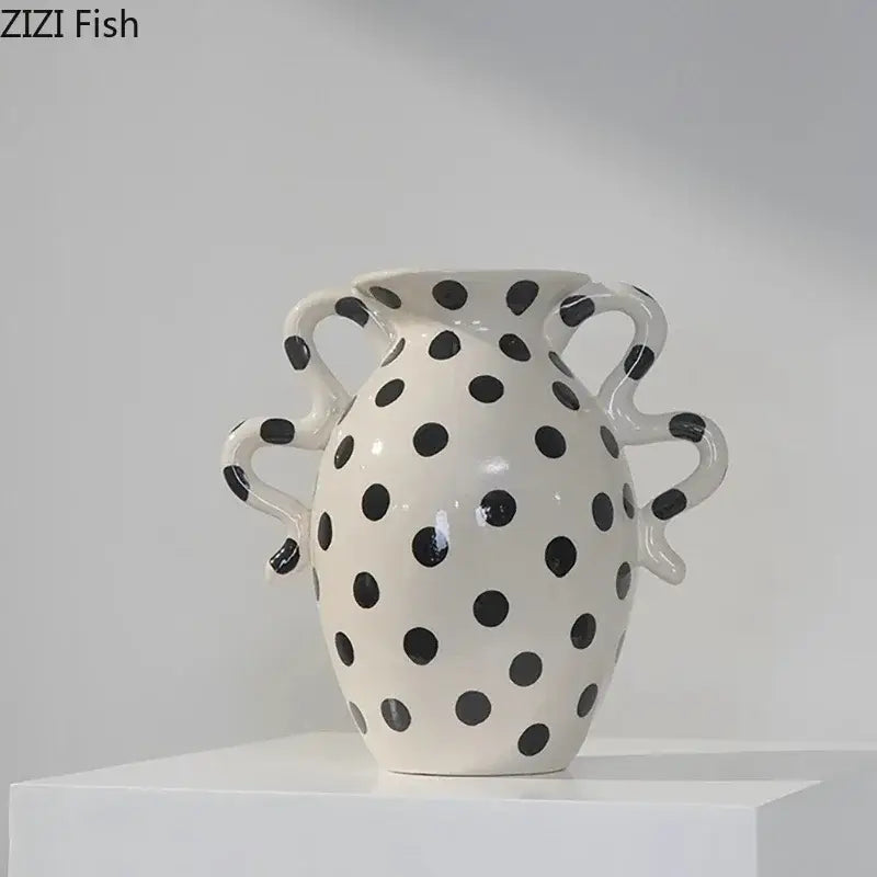 White ceramic vase with black polka dot pattern and wavy sculpted handles for living room decor