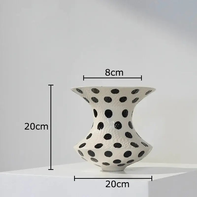 White ceramic vase with flared top and rounded base featuring evenly spaced black polka dot pattern for living room decor