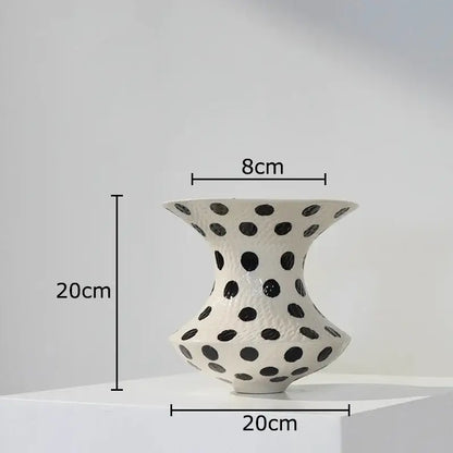 White ceramic vase with flared top and rounded base featuring evenly spaced black polka dot pattern for living room decor