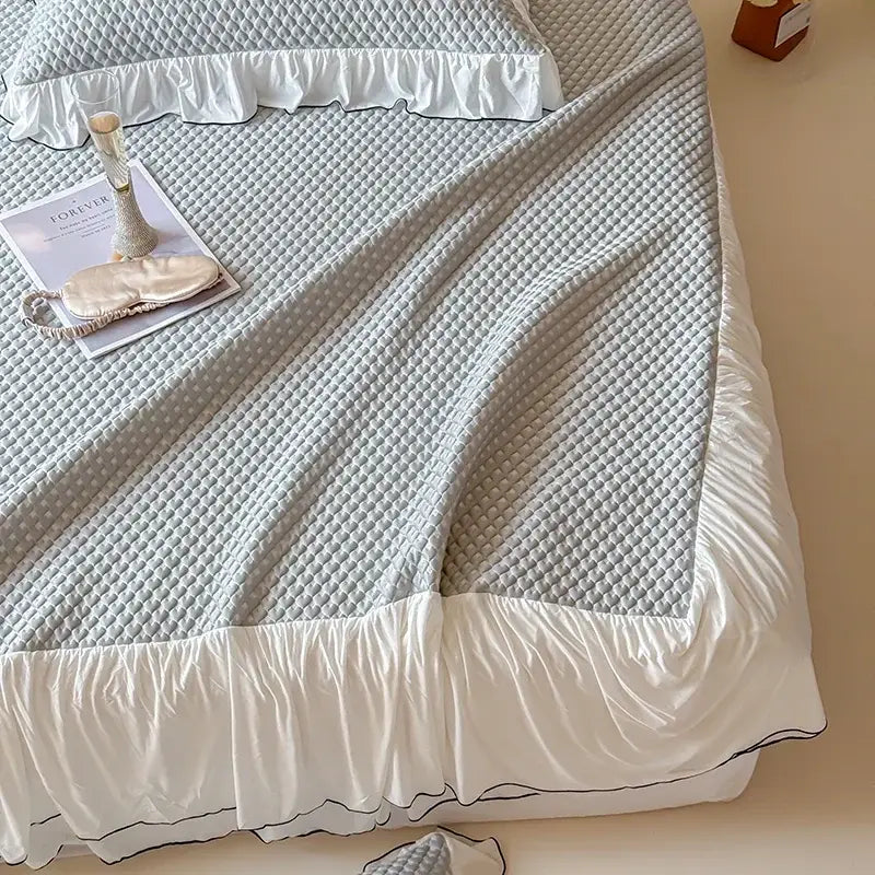 Light gray quilted bedding set with textured pattern and white ruffled edges for decorbites cool feeling bedroom decor