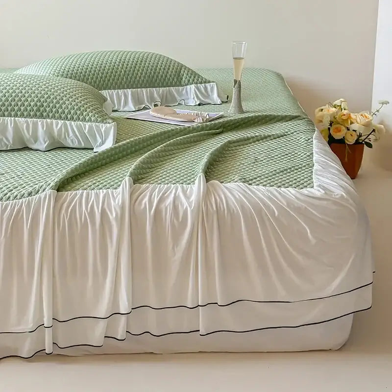 A soft mint green quilted bedding set with black piping and white ruffled skirt from decorbites cool feeling collection