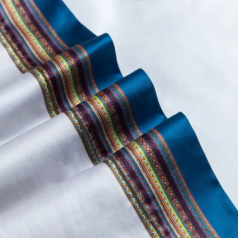 A richly patterned blue satin ribbon with gold, maroon, and green designs in a galloping horse luxury bedding set decor