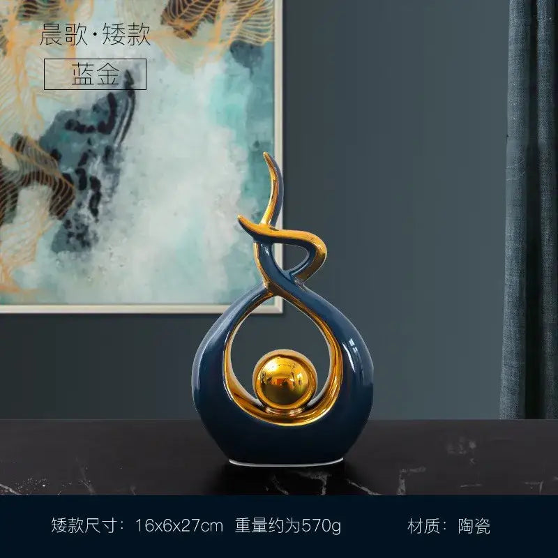 White and gold ceramic abstract figurine set featuring a blue and gold decorbites ceramic abstract sculpture with a golden sphere