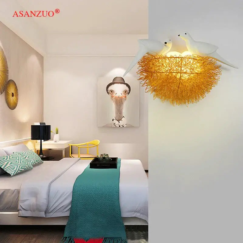 White and gold ceramic birds nest wall lamp with golden wire nest and two white bird sculptures for children room