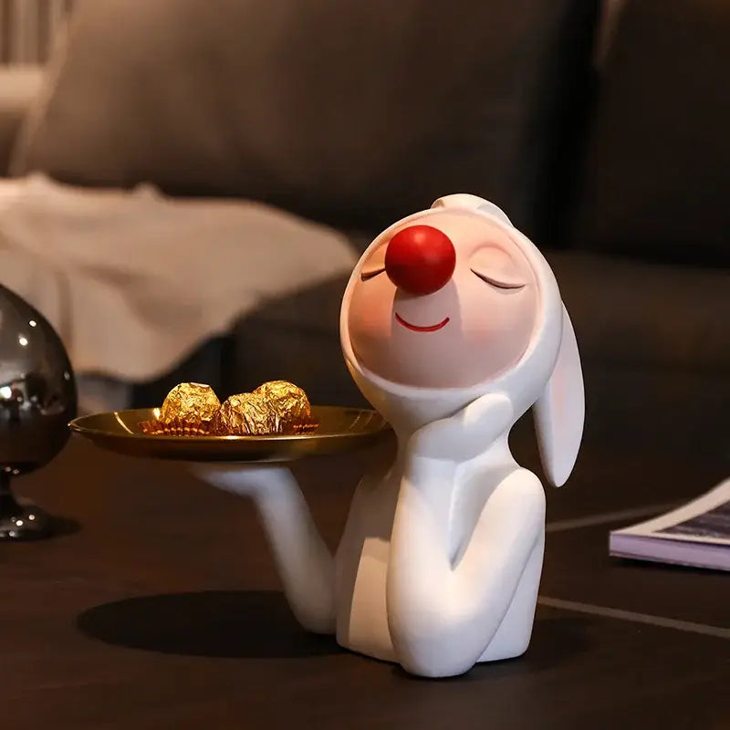 White and gold ceramic clown bust sculpture with red nose and closed eyes holding candy tray for kids room decor