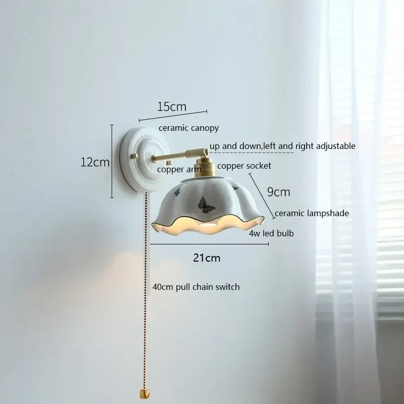 White and gold ceramic led wall light featuring a fluted butterfly lampshade and brass-finished copper arm decorbites ceramic led