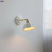 White and gold ceramic led wall light with gold-toned metal arm and decorative circular base decorbites ceramic led wall
