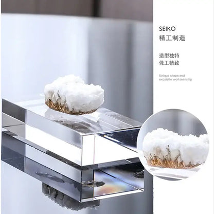 A white and gold crystal coralline ornament with golden mineral inclusions on a transparent acrylic stand for decor