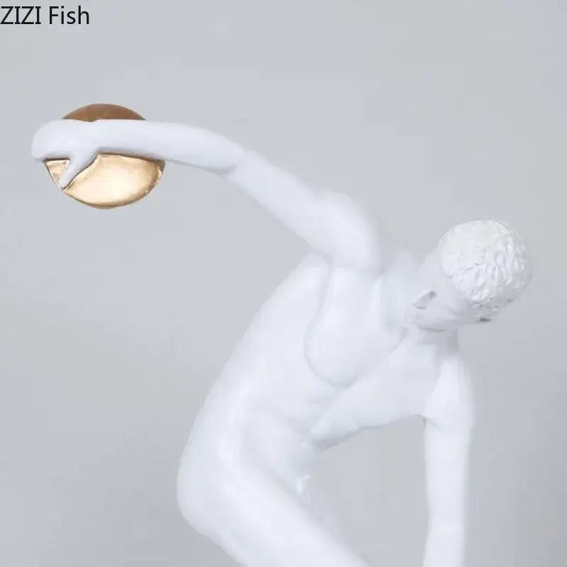 White and gold discus thrower resin sculpture of a male athlete in mid-throw for living room decor
