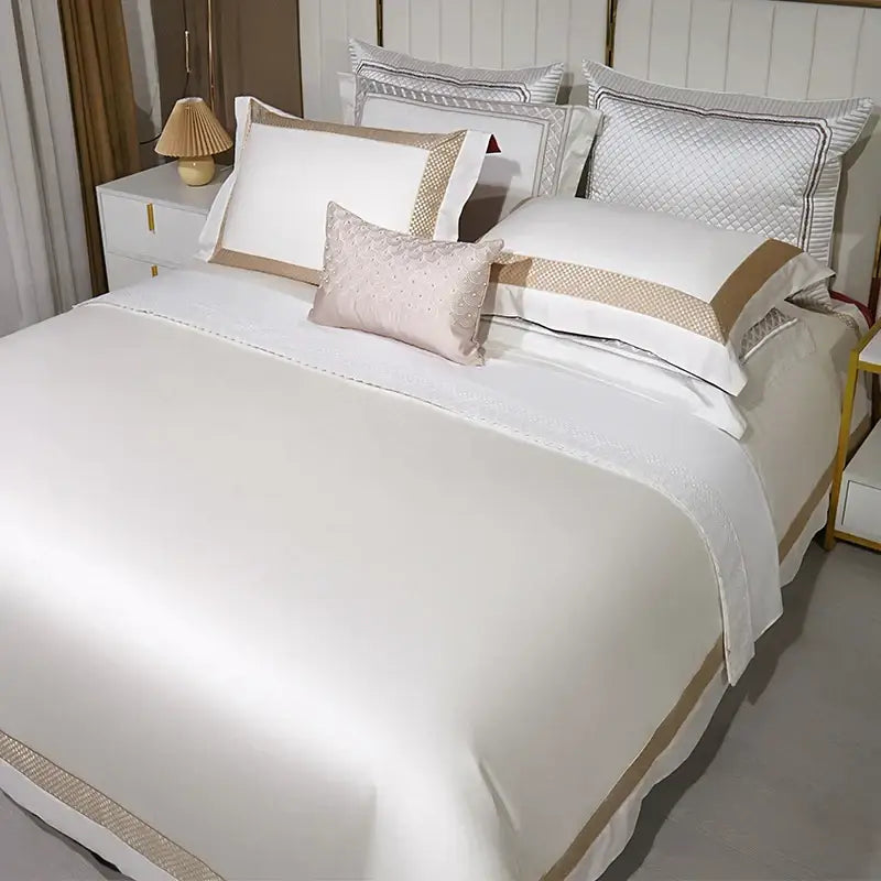 Elegant white egyptian cotton bedding set with gold embroidery featuring satin duvet cover and subtle textured detailing