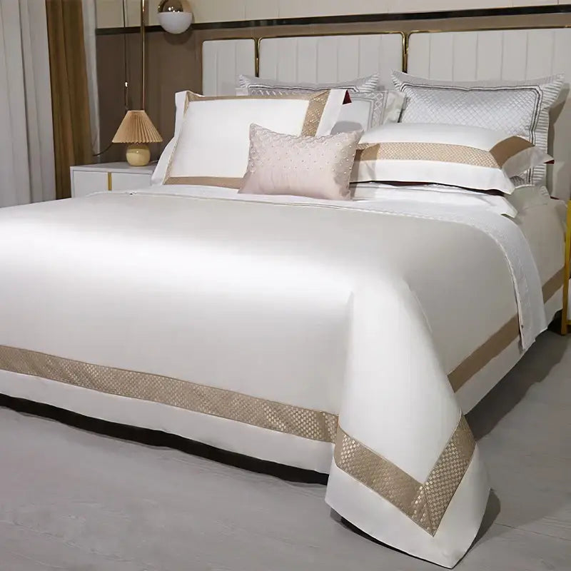 Elegant white satin egyptian cotton bedding set with gold embroidery and gold-toned woven trim and matching pillowcases