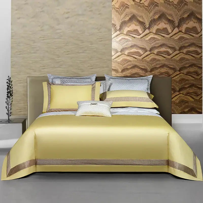 Luxurious golden-yellow satin bedspread with elegant brown trim in white and gold egyptian cotton bedding set with gold embroidery