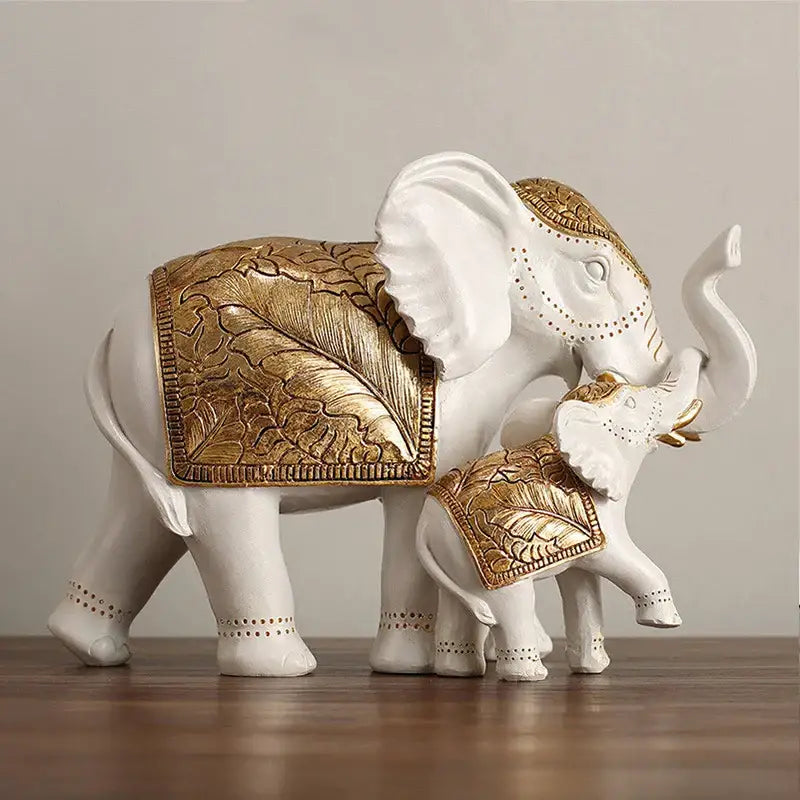 White and gold elephant sculpture figurine with intricate gold leaf saddles for elegant living room decor
