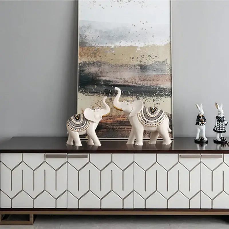 White ceramic elephant sculpture figurine with intricate black and gold geometric patterns for living room decor