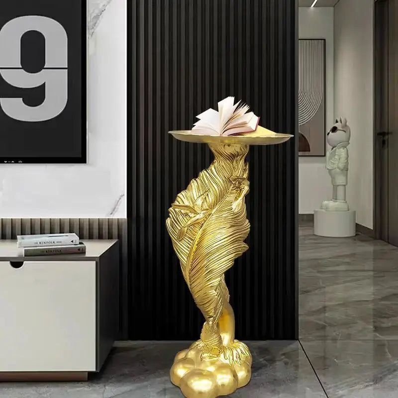 Golden feather floor decoration pedestal with flat top holding open book for white and gold feather floor living room use
