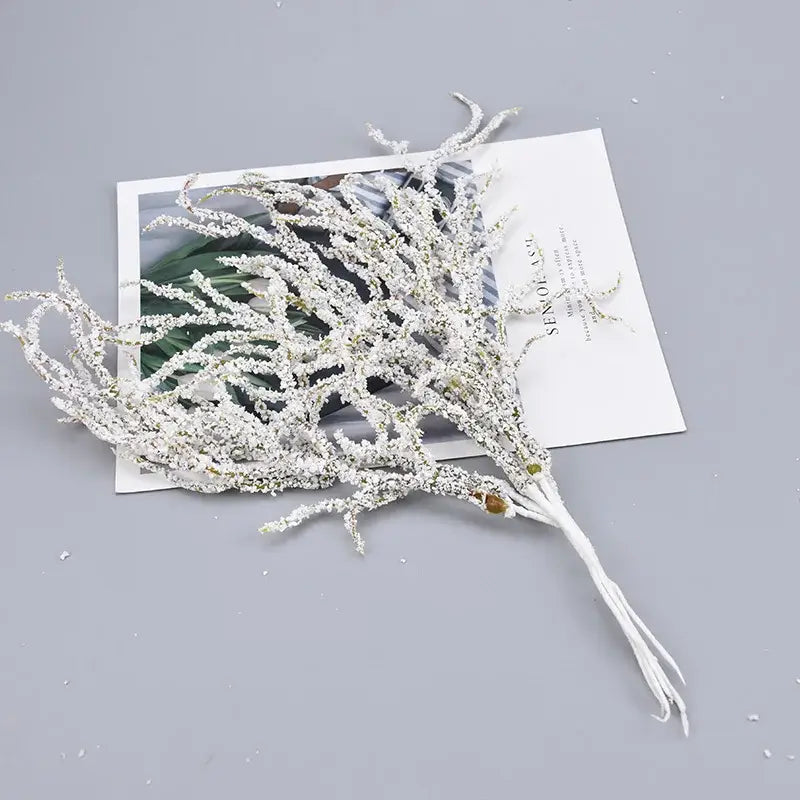 A delicate white frosted decorbites artificial branches arrangement with tiny bead accents for branches home decor