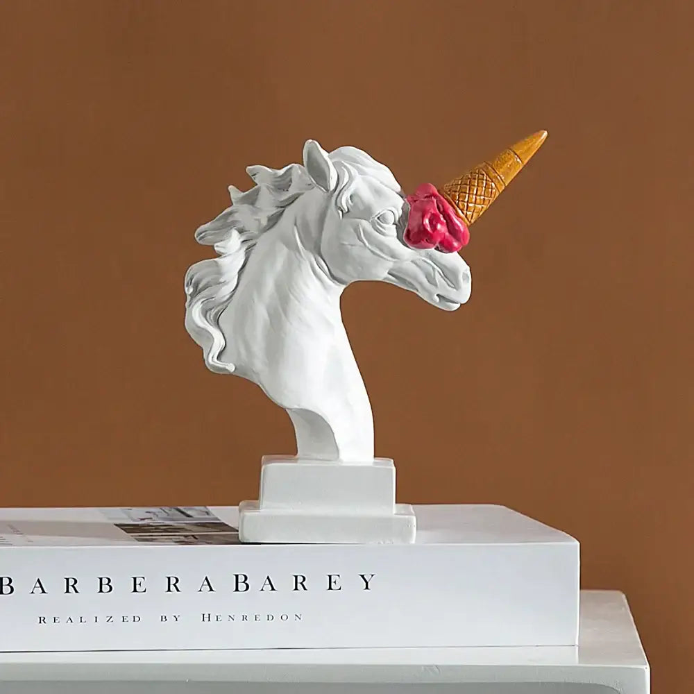 White and gold ice cream horse head sculpture in glossy resin featuring a pink scoop on the horn for office decorbites decor