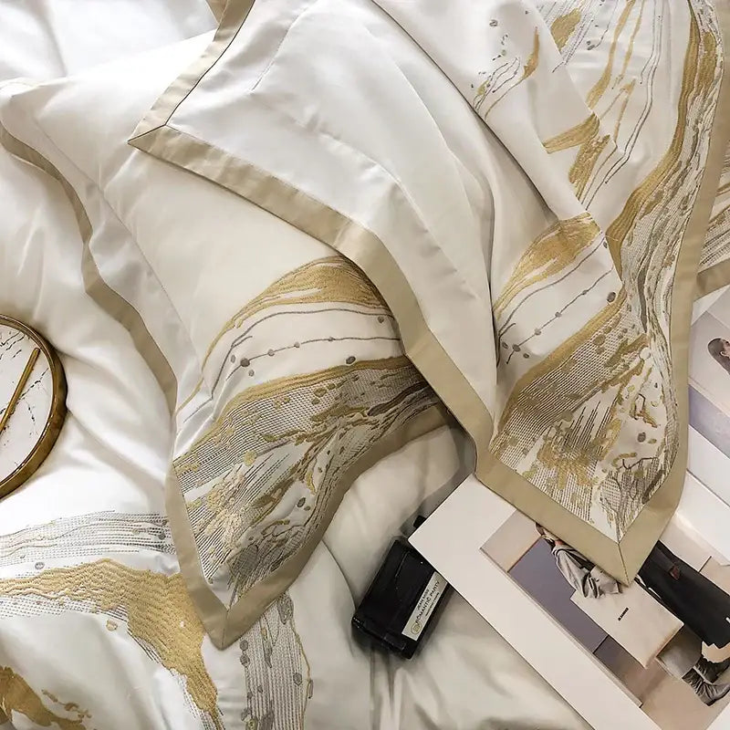 Elegant white satin egyptian cotton luxury bedding set with gold and silver abstract embroidery along edges