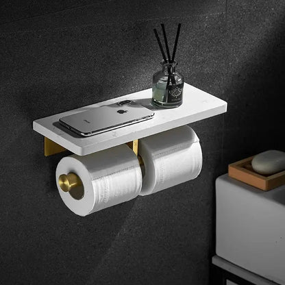 White and gold marble toilet paper holder bathroom shelf with gold marble brackets holding two rolls and a silver iphone
